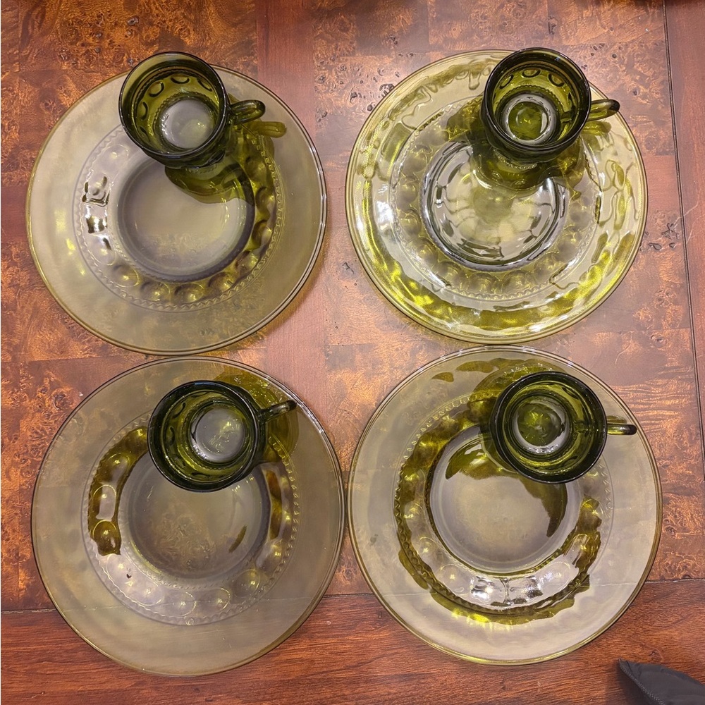 Set of four green Indiana Glass Kings Crown Thumbprint plates and cups.
